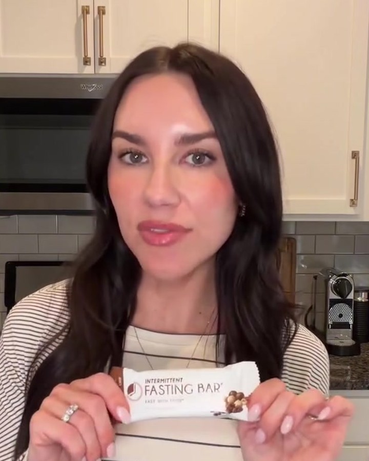 Jennifer Mazonas in her kitchen holding a wrapped Prolon Fasting Bar